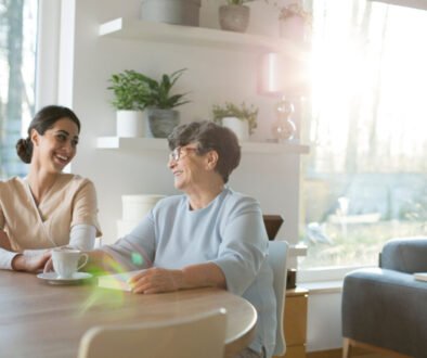 Two women enjoying coffee and conversation at home.