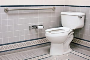 Clean restroom with toilet and grab bar.