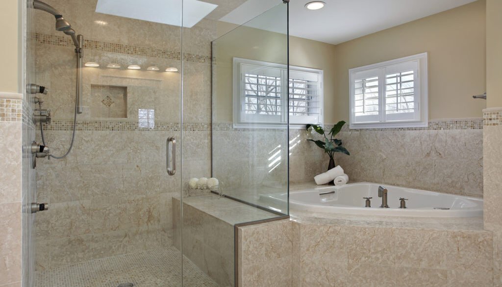 Modern bathroom featuring a glass shower and tub.