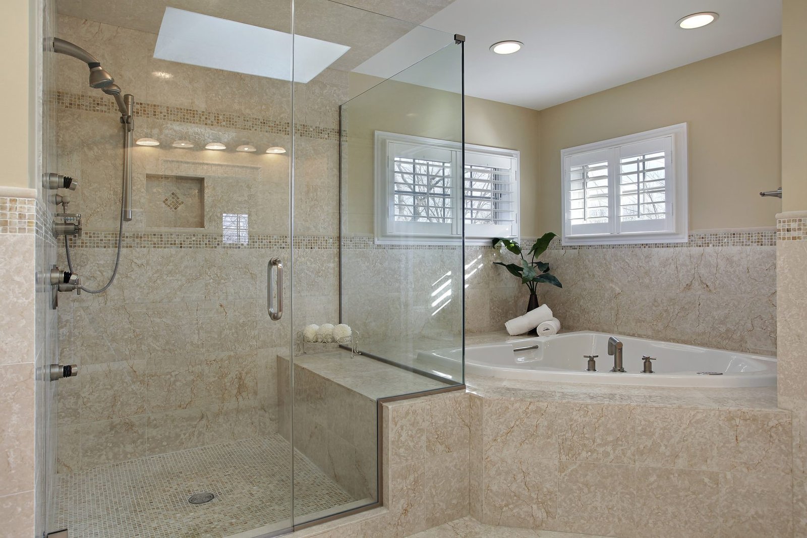 Modern bathroom featuring a glass shower and tub.