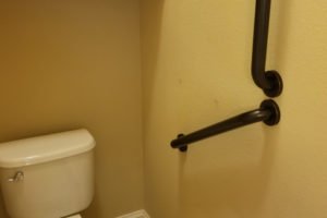Accessible restroom with grab bars and toilet.