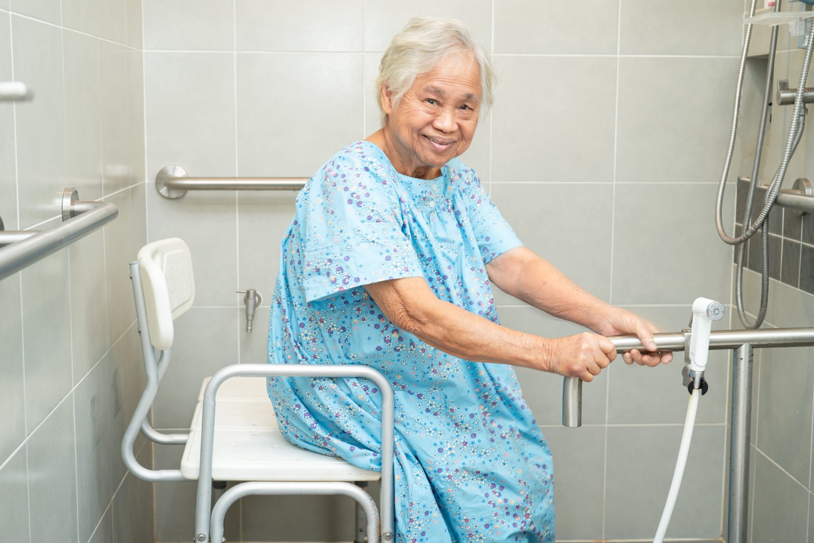 Senior woman sitting in a shower chair.