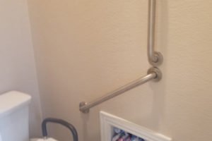 Accessible bathroom with grab bar and storage
