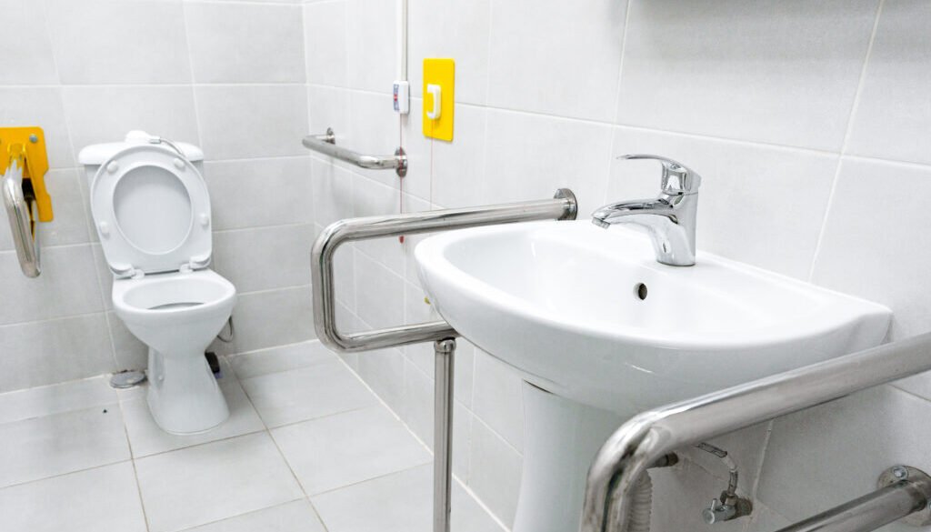 Accessible bathroom with toilet and sink.