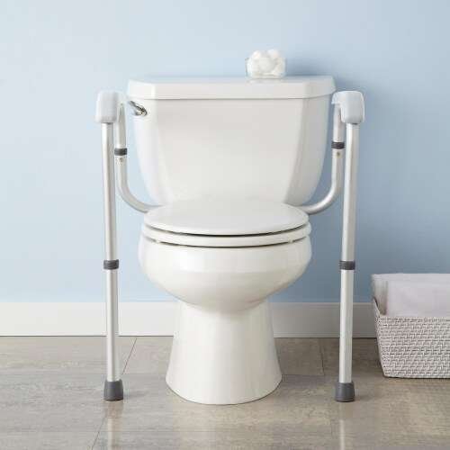 Toilet with support rails for accessibility.