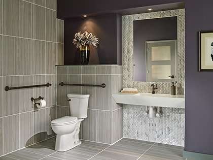 Modern bathroom with gray tiles and stylish decor.