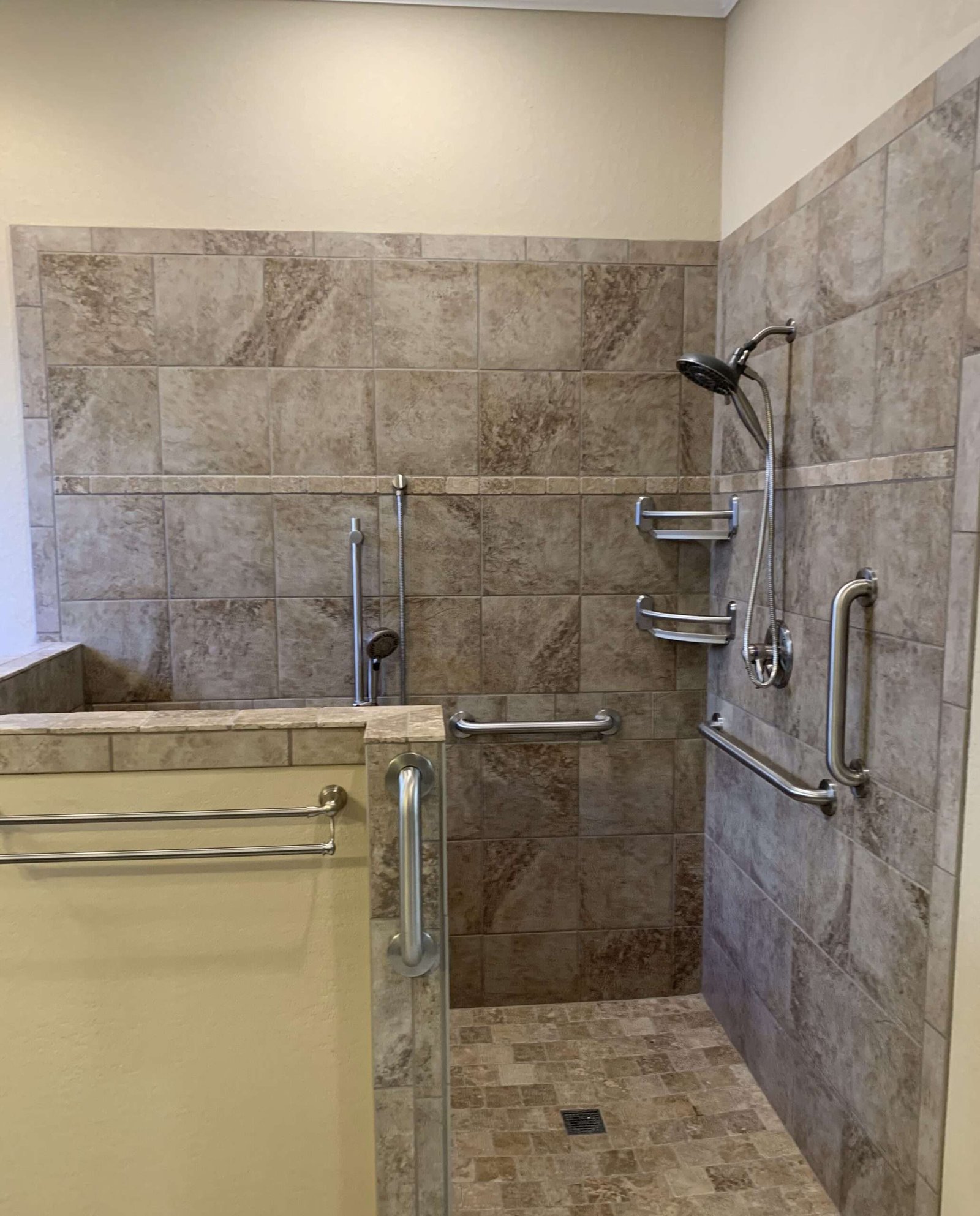 Accessible shower with grab bars and tiled walls