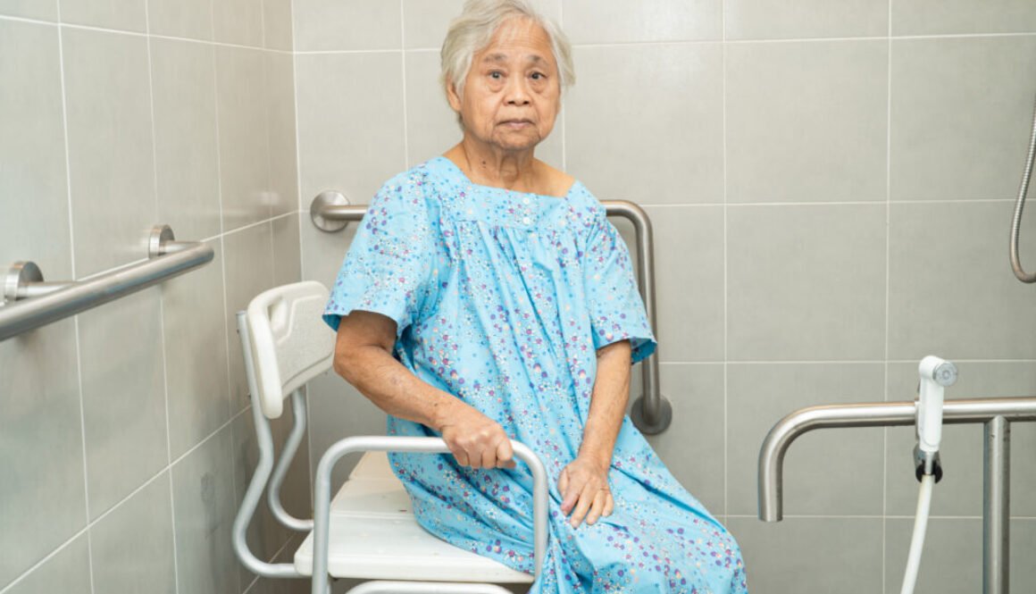 Elderly woman sitting on shower chair
