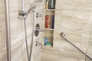 Modern shower with shelves and grab bar.