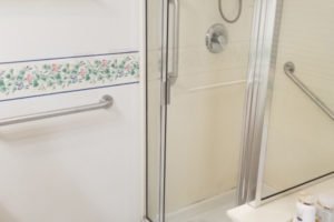 Modern bathroom with a glass shower and amenities.