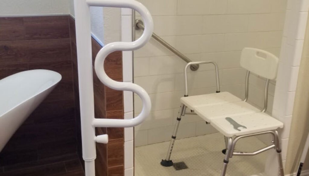Accessible shower with grab bars and transfer bench.