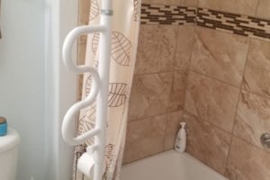 Bathroom with shower curtain and toilet paper holder