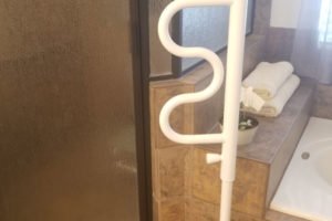 White grab bar in a bathroom setting