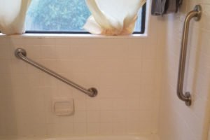 Clean bathroom with bathtub and window curtains