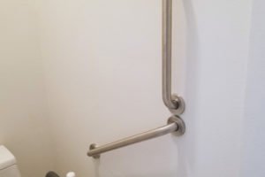 Grab bars installed beside a toilet for support.