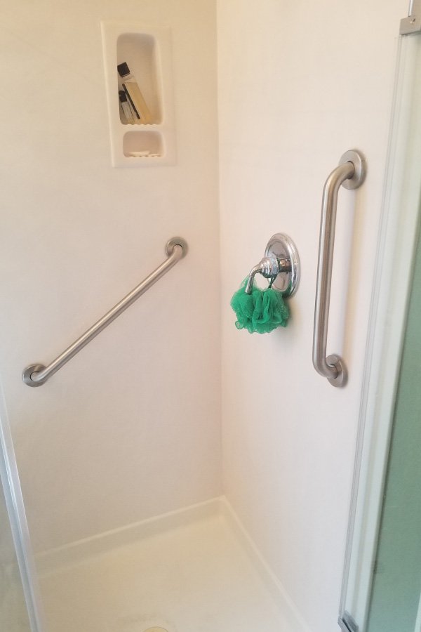 Shower with grab bars and a loofah