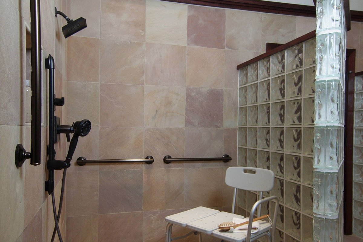 Accessible bathroom with shower and seating area.
